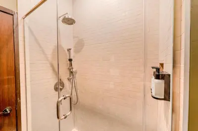 a shower with a glass door in a bathroom at Self Check-In Boutique Hotel - Quartier latin - Room 202 in Montréal