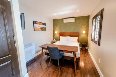 a bedroom with a bed and a wooden table at Self Check-In Boutique Hotel - Quartier latin - Room 203 in Montréal