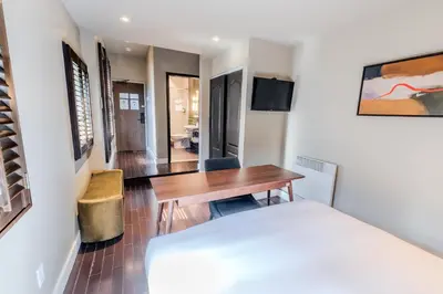 a bedroom with a bed and a desk and a table at Self Check-In Boutique Hotel - Quartier latin - Room 203 in Montréal