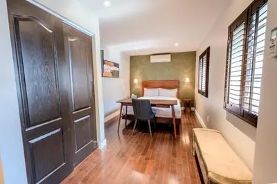 a room with a bed and a table and a door at Self Check-In Boutique Hotel - Quartier latin - Room 203 in Montréal