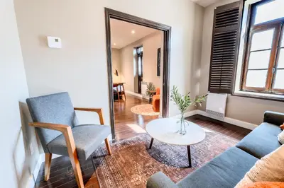 a living room with a couch and a table at Self Check-In Boutique Hotel - Quartier latin - Room 301 in Montréal