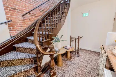 a stairwell with a brick wall and a wooden spiral staircase at Self Check-In Boutique Hotel - Quartier latin - Room 301 in Montréal