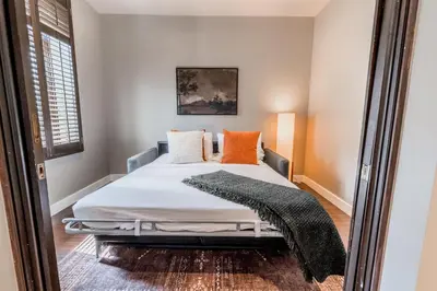 a bedroom with a bed and a mirror at Self Check-In Boutique Hotel - Quartier latin - Room 301 in Montréal