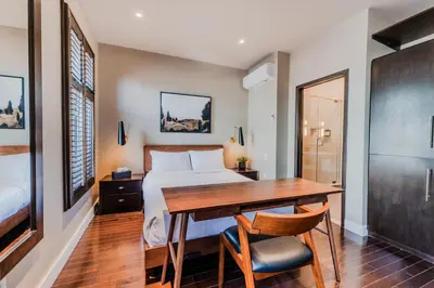 a bedroom with a bed and a wooden table and chairs at Self Check-In Boutique Hotel - Quartier latin - Room 302 in Montréal