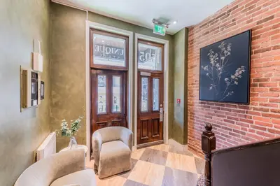 a lobby with chairs and a brick wall at Self Check-In Boutique Hotel - Quartier latin - Room 302 in Montréal