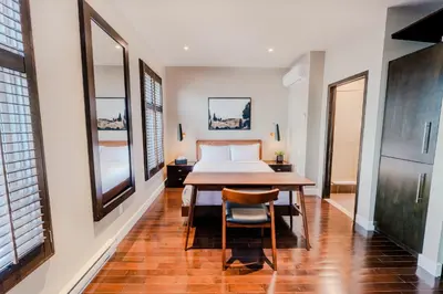 a bedroom with a bed and a table and chairs at Self Check-In Boutique Hotel - Quartier latin - Room 302 in Montréal