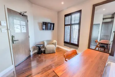 a living room with a wooden floor and a door at Self Check-In Boutique Hotel - Quartier latin - Room 302 in Montréal