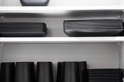 a shelf with plates and bowls on it at Amazing 4-Bedrooms in Homa Montreal 20 in Montréal