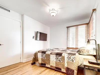 a bedroom with a bed and a window at Amazing 4-Bedrooms in Homa Montreal 20 in Montréal