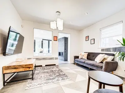 a living room with a couch and a table at Amazing 4-Bedrooms in Homa Montreal 20 in Montréal