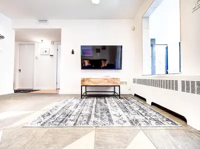 a room with a table and a tv on the wall at Amazing 4-Bedrooms in Homa Montreal 20 in Montréal