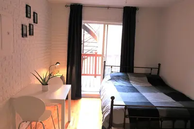 a bedroom with a bed and a table and a window at Cozy studio in montreal in Montréal