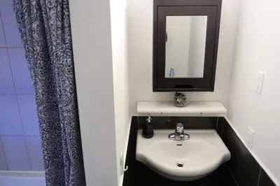 a bathroom with a sink and a mirror at Cozy studio in montreal in Montréal