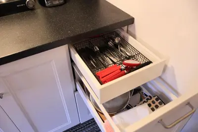 a kitchen counter with a drawer with utensils at Cozy studio in montreal in Montréal