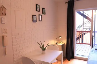 a room with a white table and a window at Cozy studio in montreal in Montréal