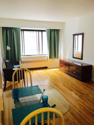 a living room with a table and a couch at Stylish Montreal Apartment Comfortable Stay in the Golden Square Mile in Montréal