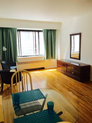 a living room with a table and a couch at Stylish Montreal Apartment Comfortable Stay in the Golden Square Mile in Montréal