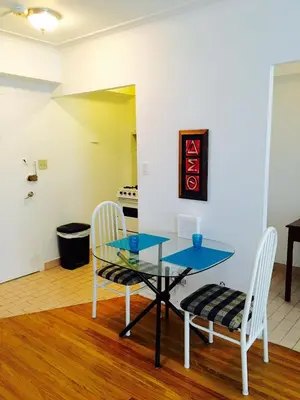 a dining room with a glass table and two chairs at Stylish Montreal Apartment Comfortable Stay in the Golden Square Mile in Montréal