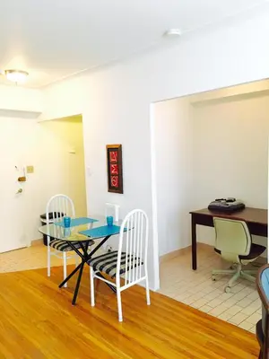 a dining room with a table and chairs and a desk at Stylish Montreal Apartment Comfortable Stay in the Golden Square Mile in Montréal