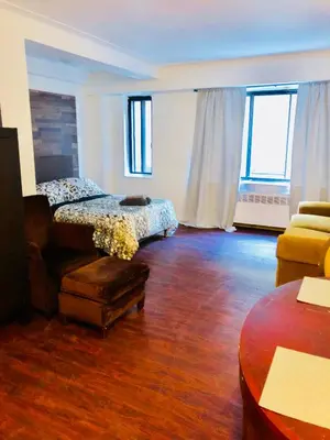 a living room with a bed and a couch at Stylish Montreal Apartment Comfortable Stay in the Golden Square Mile in Montréal