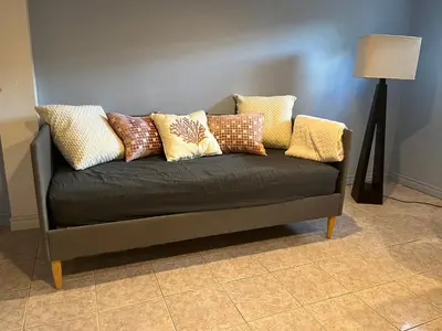 a couch with pillows on it in a room at Zen Space in perfect location! in Montréal