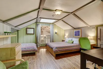 a bedroom with a bed and a desk and a table at View and access to Lake Orford - Spa - Australe in Austin