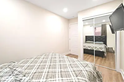 a bedroom with a bed and a mirror at Fancy 3 BDR in Heart of Plateau B in Montréal