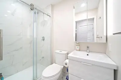 a bathroom with a toilet and a sink and a shower at Fancy 3 BDR in Heart of Plateau B in Montréal