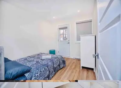 a bedroom with a bed and a window and a door at Elegant 3BDR in Heart Of Plateau 8B in Montréal