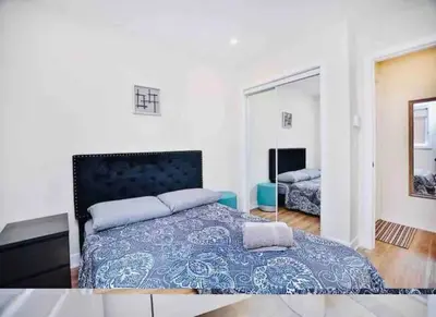 a bedroom with a large bed and a mirror at Elegant 3BDR in Heart Of Plateau 8B in Montréal