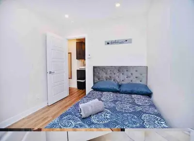 a bedroom with a large bed with blue pillows at Elegant 3BDR in Heart Of Plateau 8B in Montréal