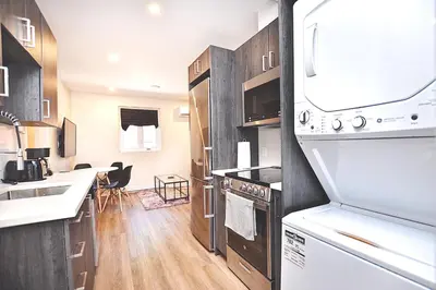 a kitchen with a sink and a stove top oven at Elegant 3BDR in Heart Of Plateau 8B in Montréal