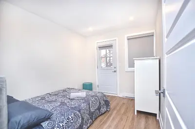 a bedroom with a bed and a window and a door at Elegant 3BDR in Heart Of Plateau 8B in Montréal