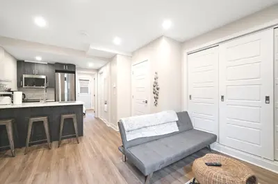 a living room with a couch and a kitchen at Elegant 1BDR in Heart Of Plateau B in Montréal
