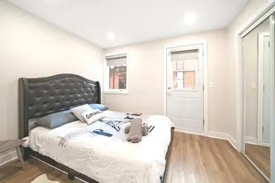 a bedroom with a bed with a black headboard at Elegant 1BDR in Heart Of Plateau B in Montréal