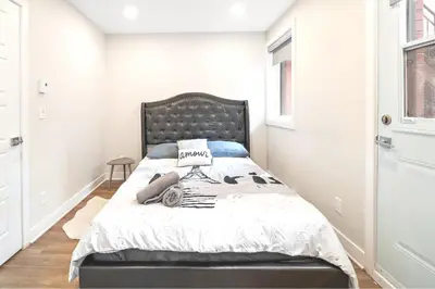 a bedroom with a bed with a black headboard at Elegant 1BDR in Heart Of Plateau B in Montréal