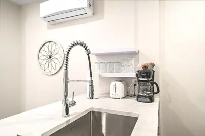 a kitchen counter with a sink and a mixer at Elegant 1BDR in Heart Of Plateau B in Montréal