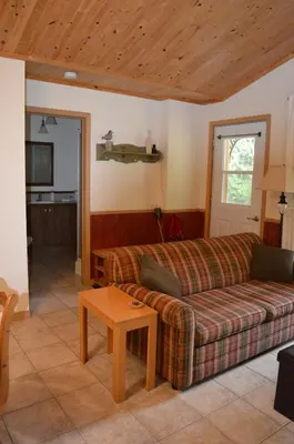 a living room with a couch and a table at Chalet Esmeralda in Piopolis