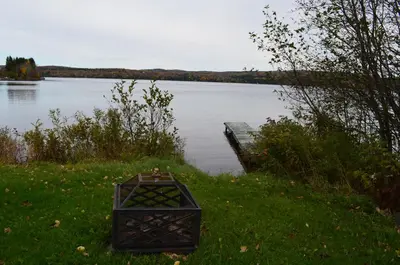 a box sitting in the grass next to a lake at Chalet Esmeralda in Piopolis