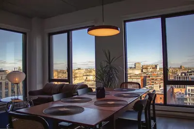 a dining room table with a view of a city at Panoramic Apartment in the old port in Montréal