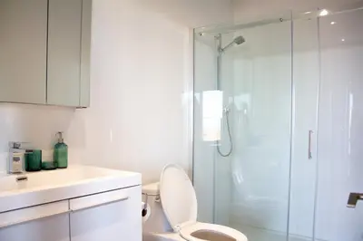a bathroom with a toilet and a glass shower at Panoramic Apartment in the old port in Montréal