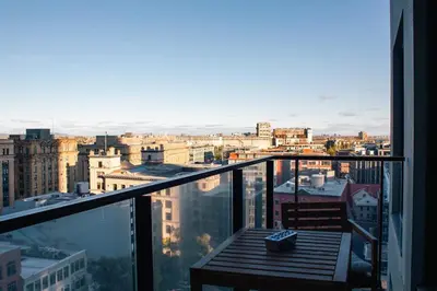 a balcony with a table and a view of a city at Panoramic Apartment in the old port in Montréal