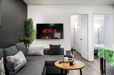 a living room with a couch and a table at Bienvenue dans votre havre de paix à Griffintown in Montréal