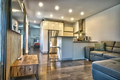 a kitchen and living room with a couch and a table at Downtown Sherby - Central, Parking, King Bed, Sleeps 3 in Sherbrooke