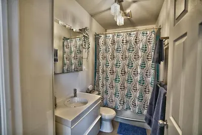 a bathroom with a sink and a toilet and a shower at Downtown Sherby - Central, Parking, King Bed, Sleeps 3 in Sherbrooke