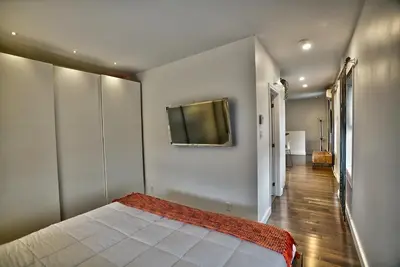a bedroom with a bed and a mirror on the wall at Downtown Sherby - Central, Parking, King Bed, Sleeps 3 in Sherbrooke