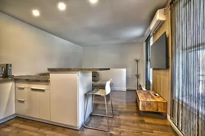 a kitchen with a wooden table and a wooden tableablish at Downtown Sherby - Central, Parking, King Bed, Sleeps 3 in Sherbrooke