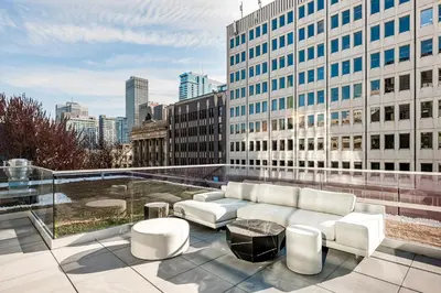 a white couch sitting on top of a building at Le Mont Apartments in Montréal