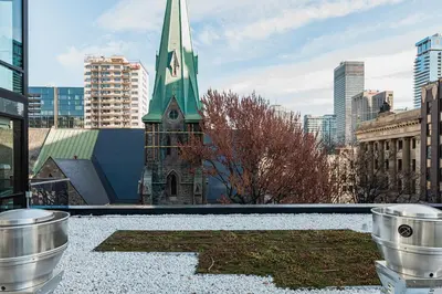 a church with a green steeple on top of a building at Le Mont Apartments in Montréal