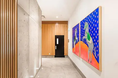a hallway with a large painting on the wall at Le Mont Apartments in Montréal